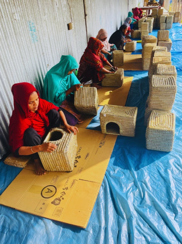 Artisans hand-crafting square-shaped natural pet houses for small animals